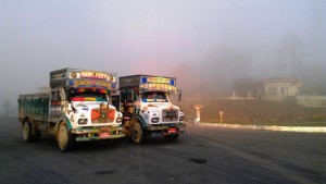 Trucks in the mist at Dochu La pass   