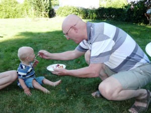 Grandpa feeding Rasmus    